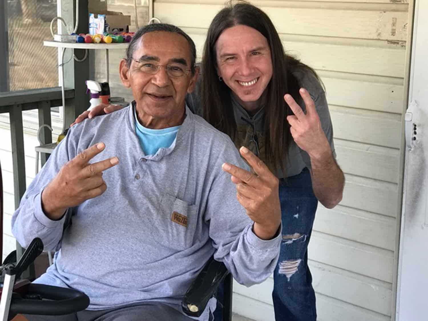 Larry Sellers and C.L. Harmon on a front porch. They are posing after an interview about Larry's celebrity status as a Native American actor.