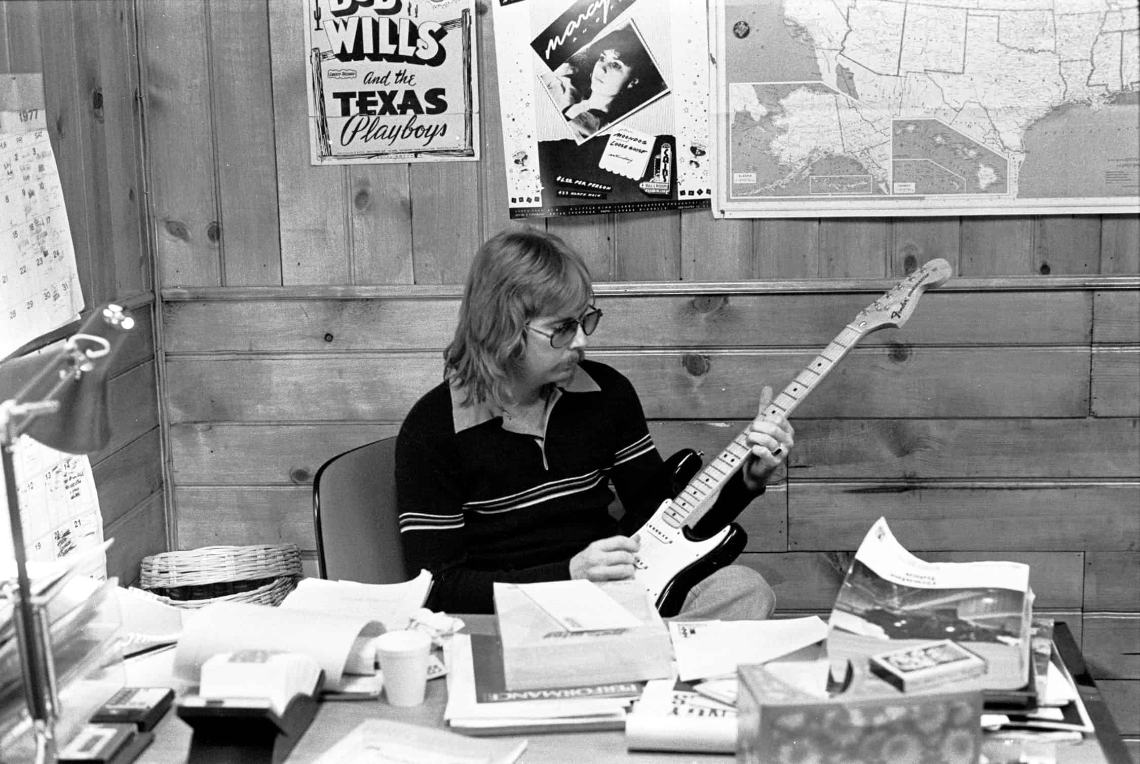 Larry Shaeffer holding guitar in Cain's Ballroom Office