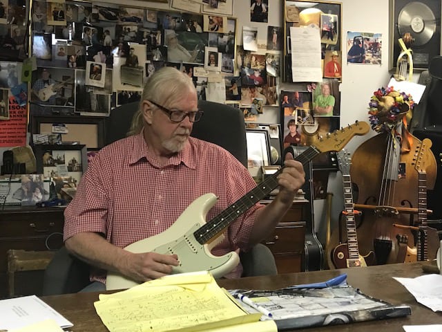 Larry Shaeffer holding guitar