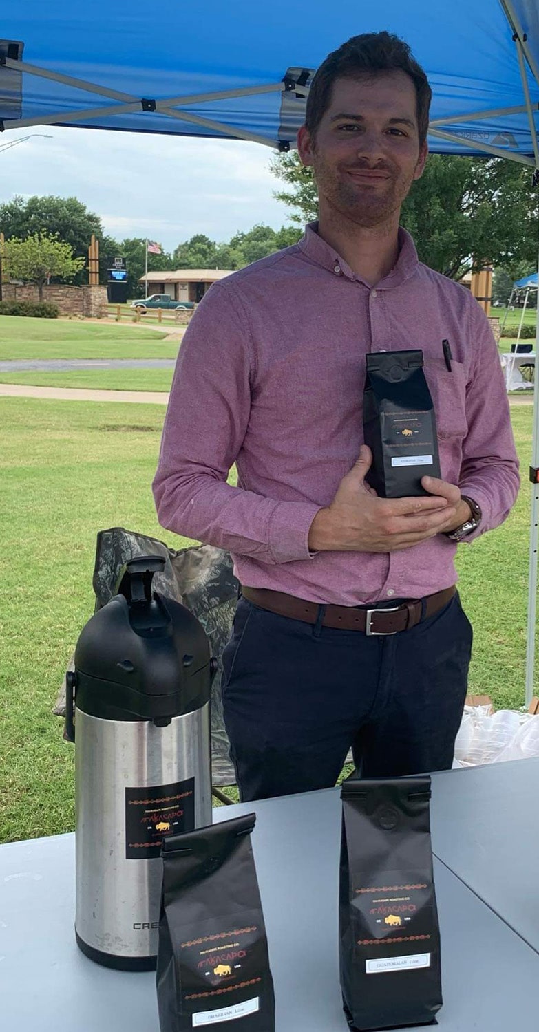 owner displaying Makasape Coffee Beans at an event